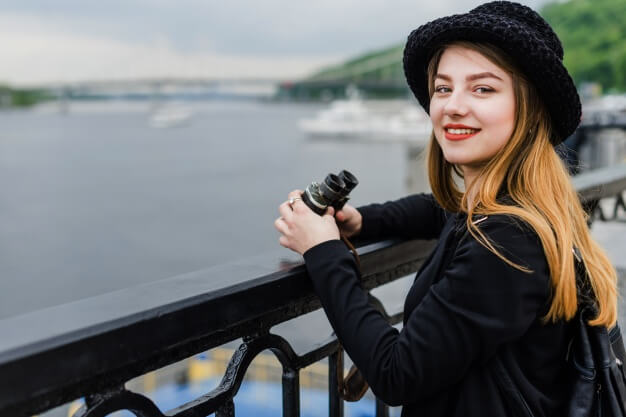 young woman holding binoculars