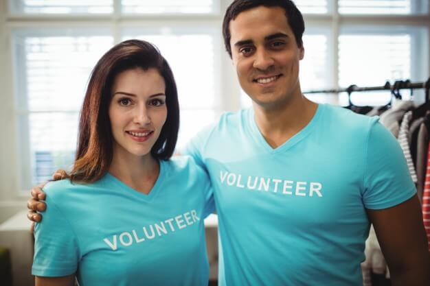 man and woman volunteers posing