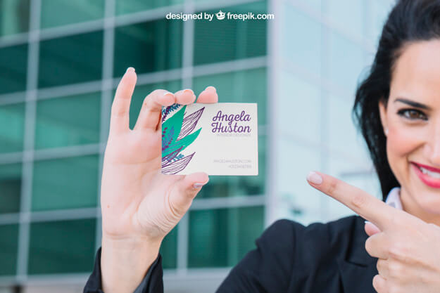 woman pointing at business card