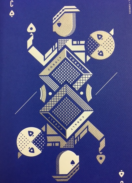artistic rendering of a playing card in white and silver ink printed on a blue paper stock