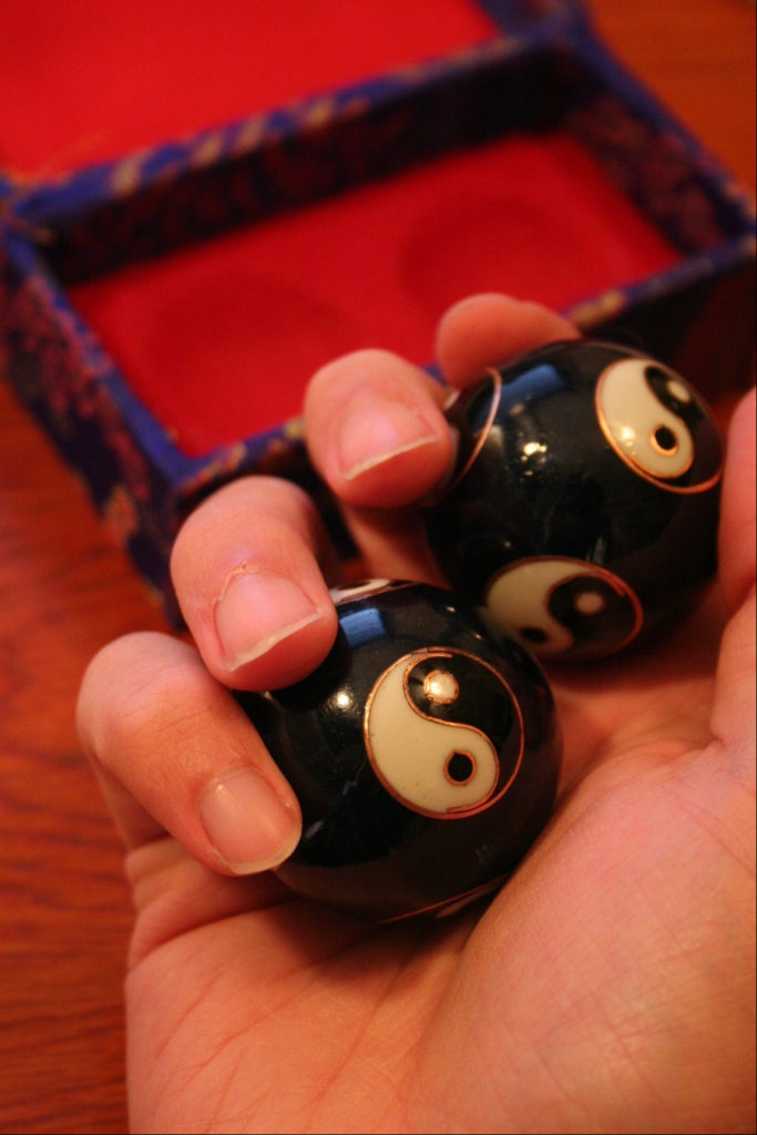 Two baoding balls held in hand